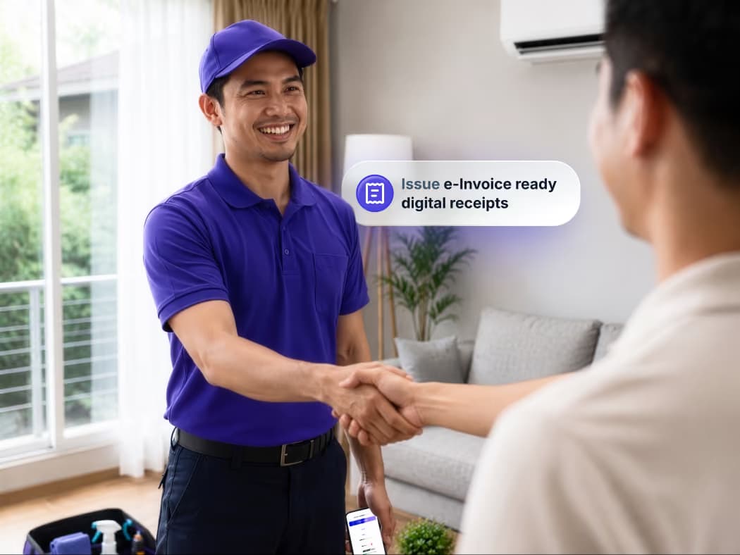 A technician shakes hand with a customer in their homes after completing a job.