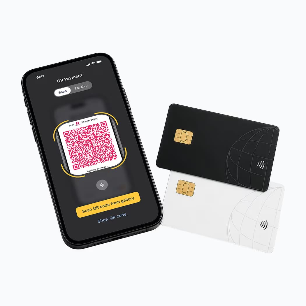 Smartphone displaying QR payment screen with two payment cards, one black and one white, nearby.